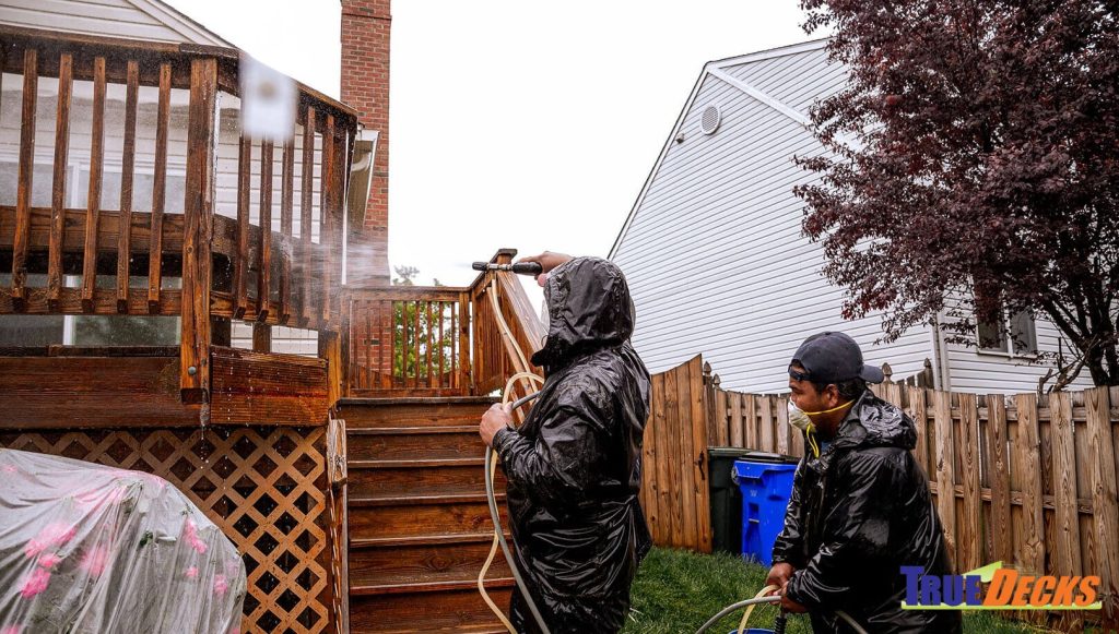 true deck workers washing a fence on deck