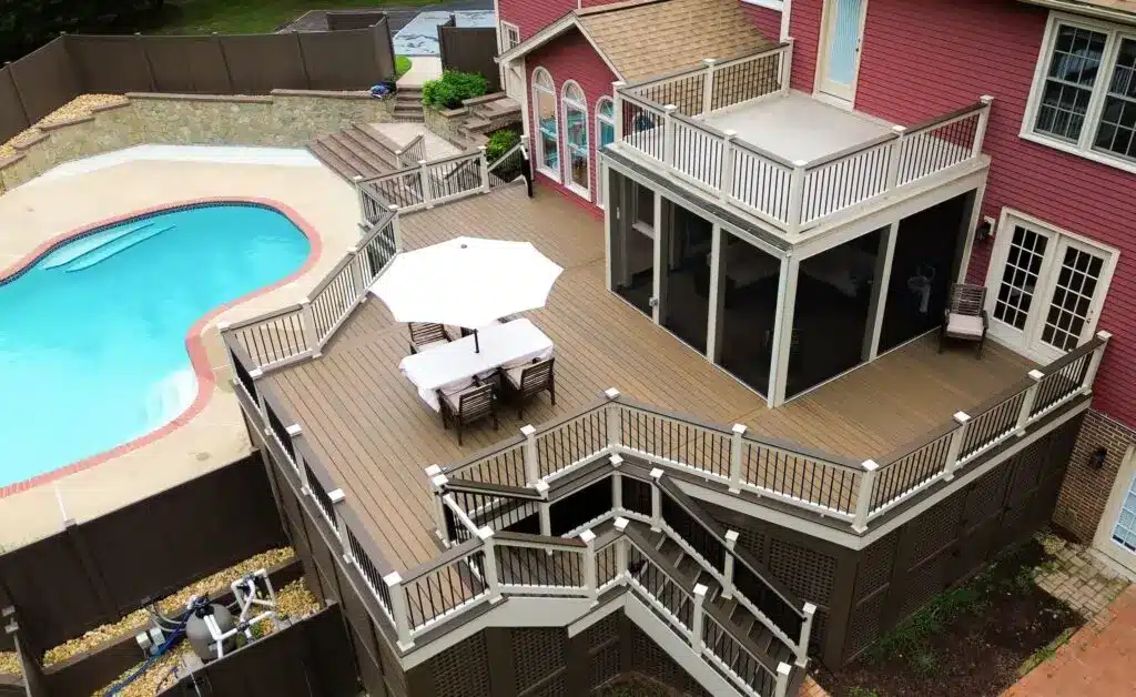 True Decks custom two-story deck porch with a screened room and white railings