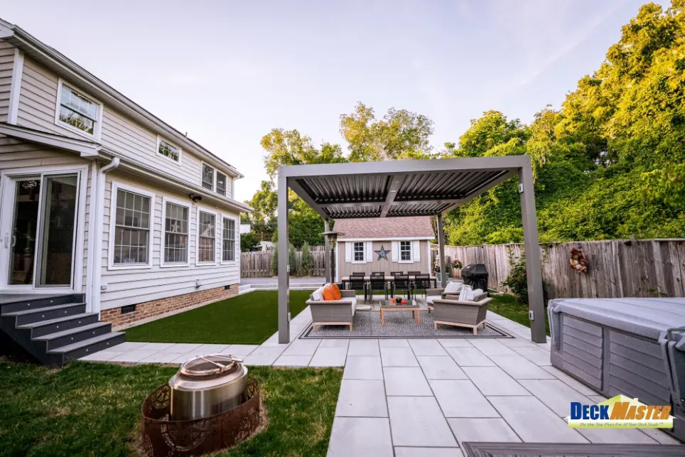 Modern louvered patio porch roof built alongside a custom backyard deck by True Decks